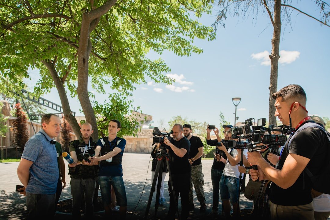 Trainer explaining camera equipment to a small group