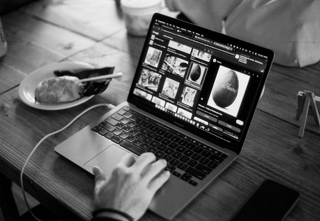 Close-up of hands editing video footage on a laptop keyboard