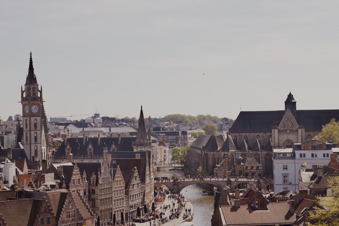 Small crew filming in a belgian town square with historic buildings