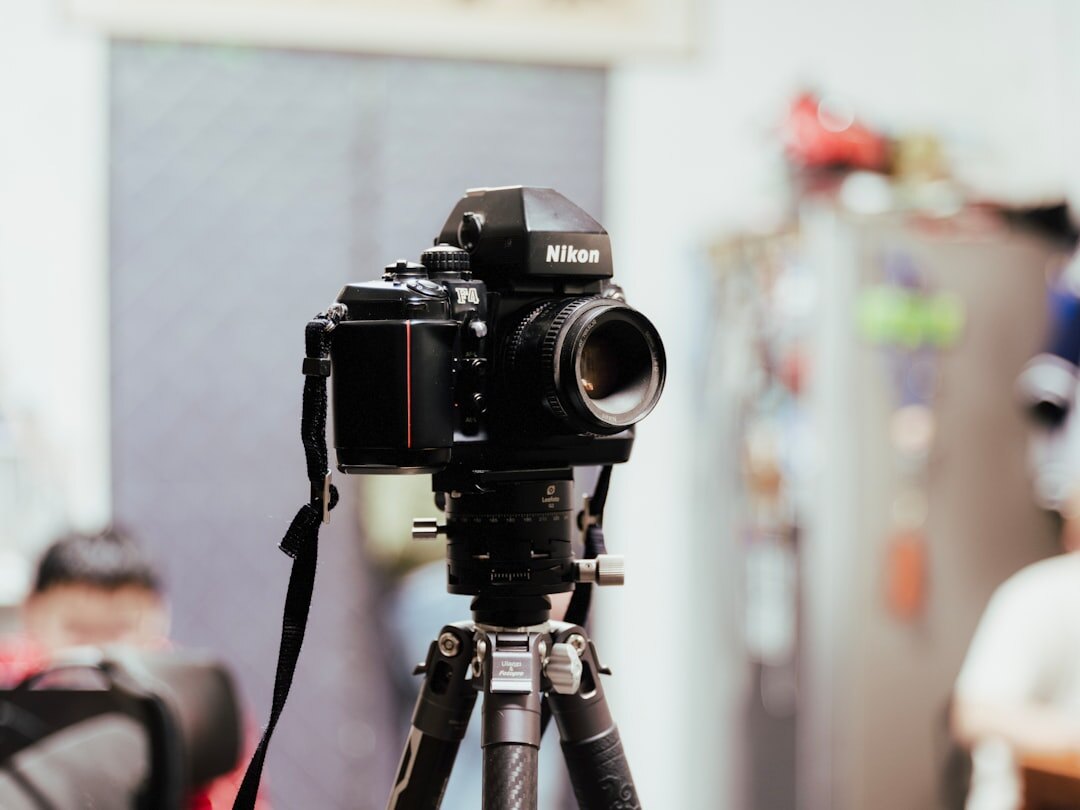 Professional video camera set up on a tripod indoors