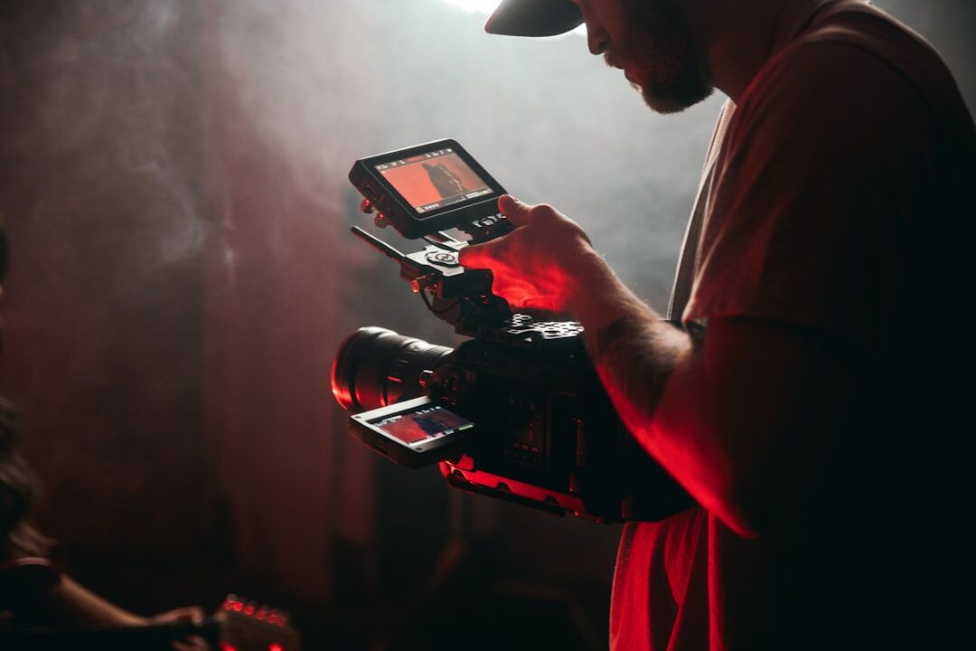 Technician preparing camera and lighting equipment before a shoot